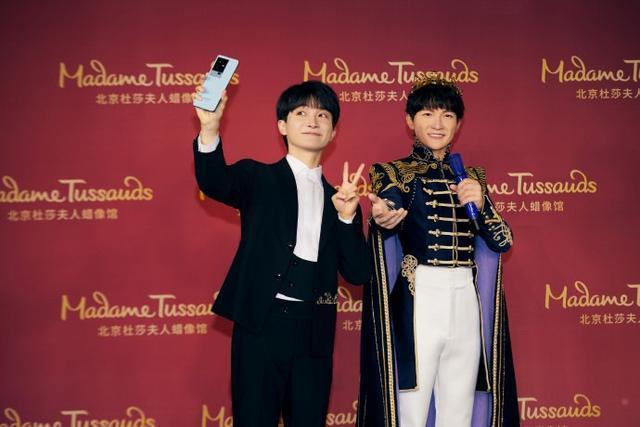 周深和纪念蜡像合影纪念出道九周年 蜡像造型逼真潇洒