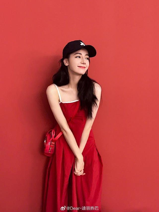 迪丽热巴微博营业晒红裙美照 戴棒球帽对镜甜笑wink