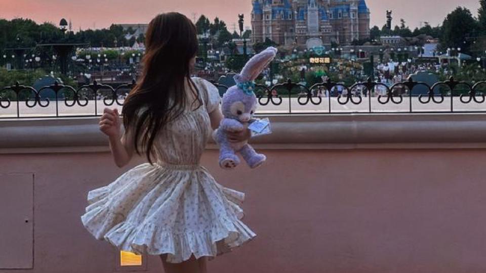 赵露思晒迪士尼游玩背影照，穿碎花裙手拿星黛露甜美可人