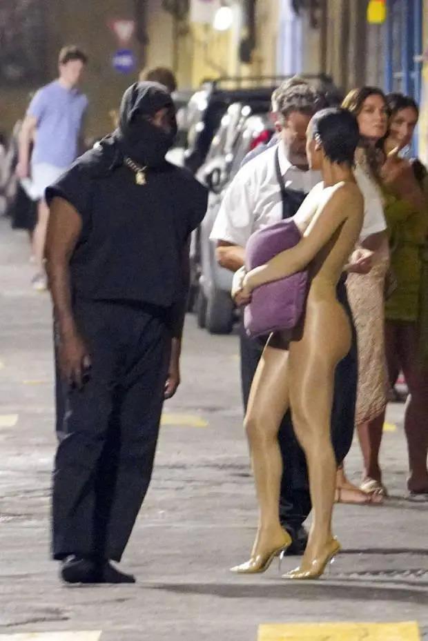 太另类！侃爷老婆又惹争议 裸色紧身服出行抱枕头遮胸